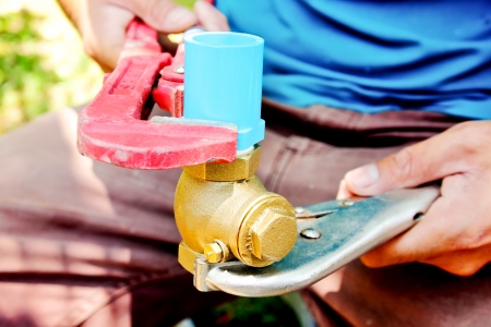Plumbers repair water pipes by tools background