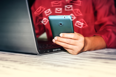 Young woman using smartphone and laptop technology background
