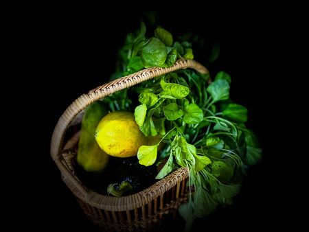 Green vegetable with papaya ripe in basket nature backgroundsの写真素材