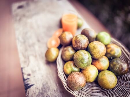 Orange and squeezed orange juice on wood table fruits and nature backgroundsの写真素材