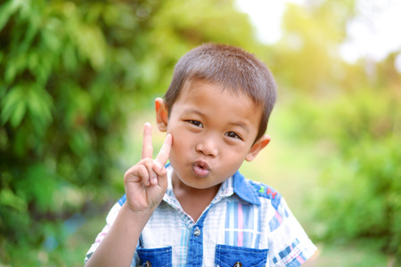 Portrait of young boy in nature, park or outdoors. cute kid outdoor. a child is smiling enjoying adopted life.の写真素材