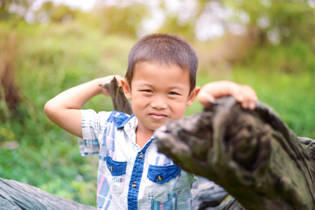 Portrait of young boy in nature, park or outdoors. cute kid outdoor. a child is smiling enjoying adopted life.の写真素材
