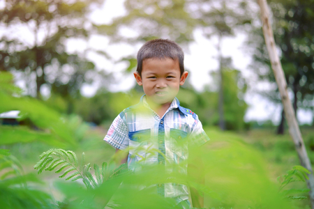 Portrait of young boy in nature, park or outdoors. cute kid outdoor. a child is smiling enjoying adopted life.の写真素材