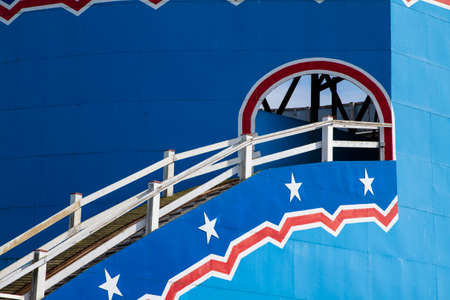 Detail of wooden panels and railings on a traditional roller coaster amusement ride at a British seaside resort.の写真素材