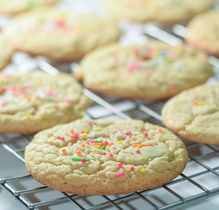 Freshly baked funfetti sugar cookies on rack, delicious homemade cookies with sprinkles