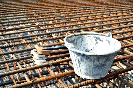 old hammer and old bucket on rust bar,tools,rust bar,industrial,concrete bucketの写真素材
