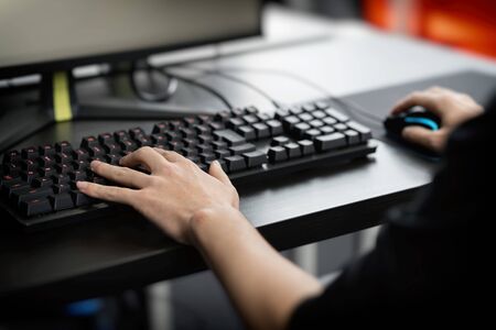 the hand of a man playing a computer game