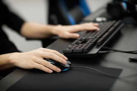 the hand of a man playing a computer game