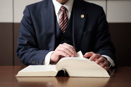 the hand of a lawyer studying lawの写真素材