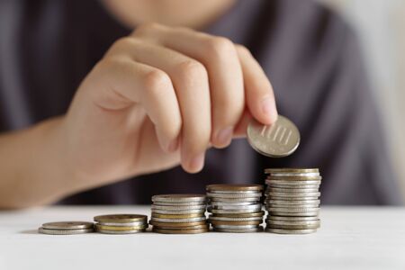 A boy in elementary school who piles up money