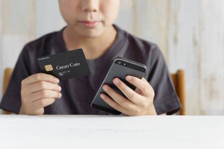 Elementary school boy trying to charge for smartphone games with credit card