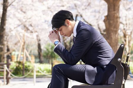 Japanese male businessman worried aboutの写真素材
