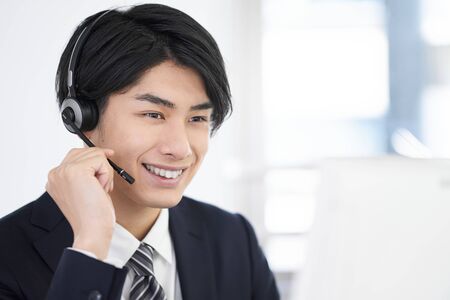 Call center men responding with a smileの写真素材