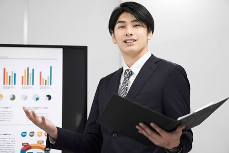 Japanese male businessman giving a presentationの写真素材