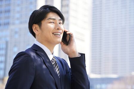 Japanese male businessman's face up to callの写真素材