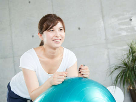Japanese woman using balance ball to plank Japanese woman using balance ball to plank