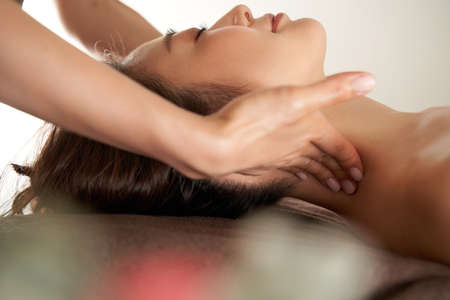 Japanese woman receiving a massage of the neck at the beauty salonの写真素材