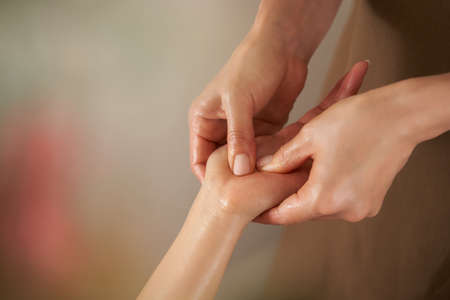 Japanese woman receiving hand massage at beauty salonの写真素材