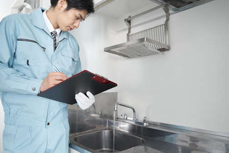 Japanese male workers checking around the waterの写真素材