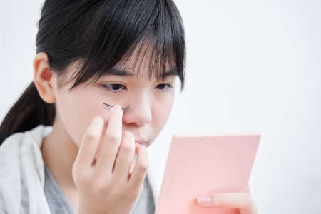 Japanese girls junior high school student wearing false eyelashesの写真素材