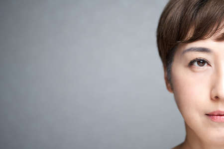 Middle-old Japanese woman with a serious expressionの写真素材