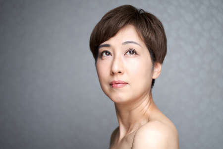 A middle-old Japanese woman with a serious expression off her eyesの写真素材