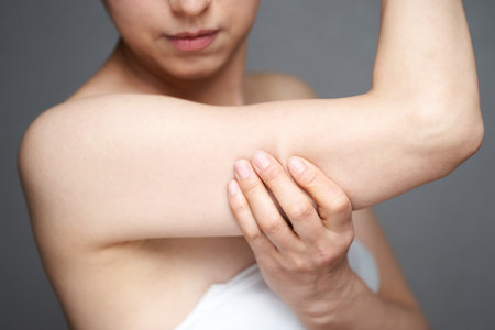 a middle-old Japanese woman who cares about the sagging of her upper armの写真素材