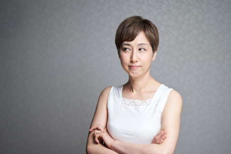 Middle-old Japanese woman thinking about beauty