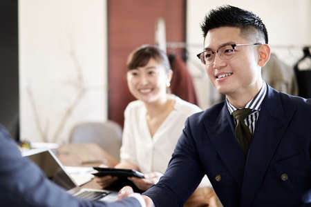 Asian businessman shaking handsの写真素材