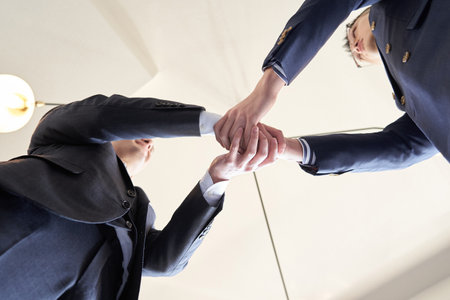 Asian businessman shaking hands at business meetingの写真素材