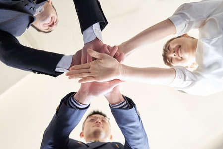 Asian businesspersons with overlapping hands
