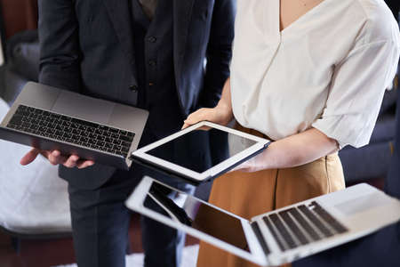 Asian business people expanding digital gadgetsの写真素材