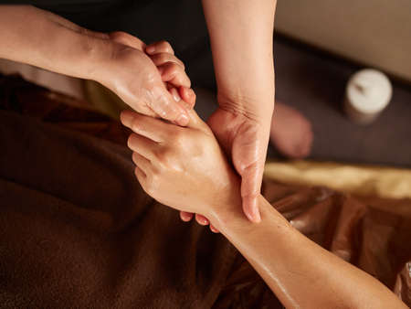 Asian man receiving finger massageの写真素材