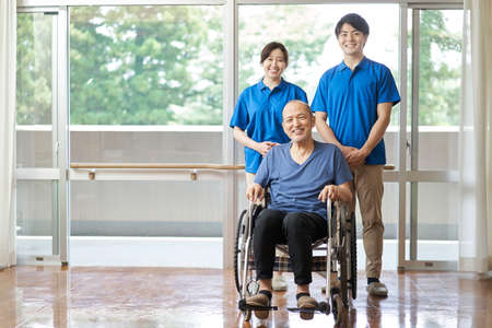 Elderly and male and female caregiversの写真素材
