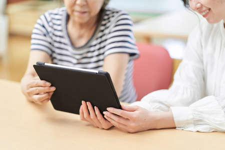 Mother and child looking at tablet together