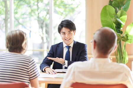 Professionals who give advice on inheritance to elderly couplesの写真素材