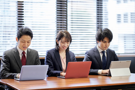 Asian business person working on a computerの写真素材