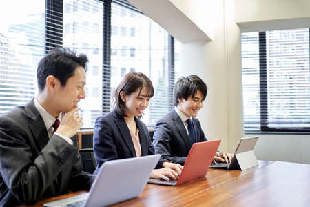 Asian business person working on a computerの写真素材
