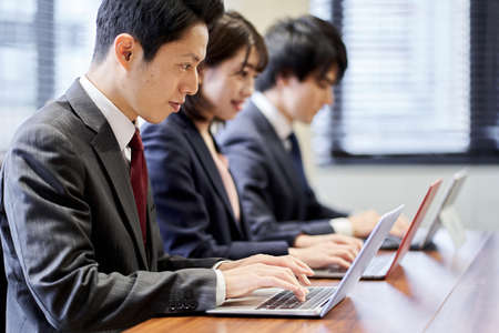 Asian business person working on a computerの写真素材