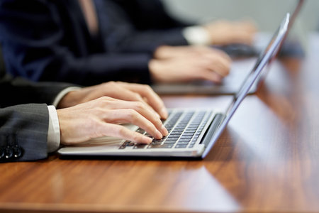 At hand of an Asian business person working on a personal computerの写真素材