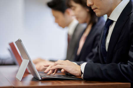 Asian business person working on a computer