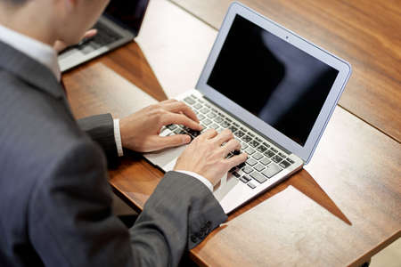 At hand of an Asian business person working on a personal computer