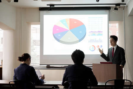 Asian businessman giving a presentation at a conferenceの写真素材