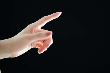 Close-up of the hand of a woman pointingの写真素材