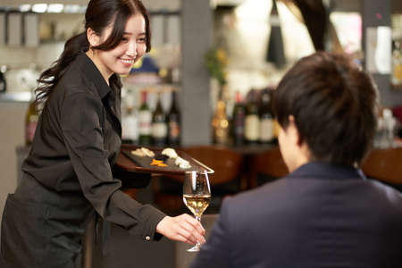 Asian female servicing at a restaurantの写真素材