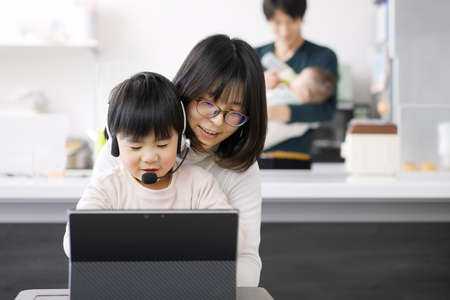 Asian female disturbed by children's telework