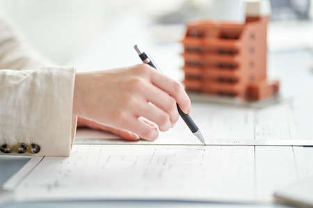 At the hands of a female architect who designs an apartmentの写真素材
