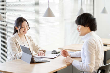 Asian business person having a real estate investment meeting in a coworking spaceの写真素材