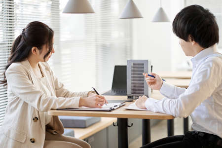 Asian real estate agent having a meeting for real estate developmentの写真素材