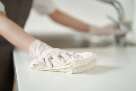 Asian woman wiping the kitchen